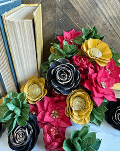 Colorful flower-shaped objects on a wooden surface with books in the background